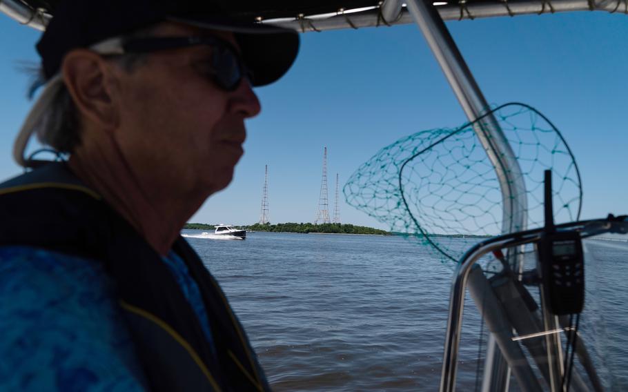 Tom Guay, program officer at the Severn River Association, drives past Greenbury Point on July 11, 2022. 