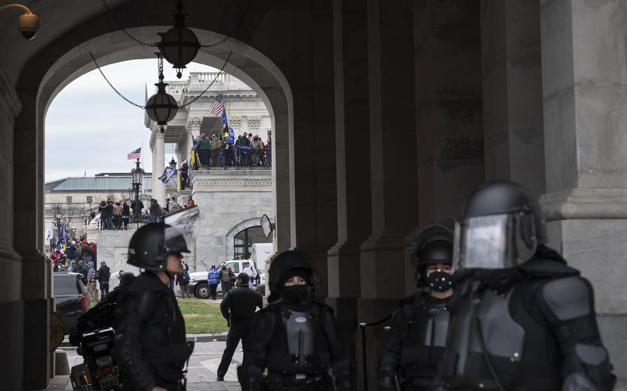 U.S. Capitol Police, in riot gear, stand in a carriageway at the Capitol in Washington on Jan. 6. 