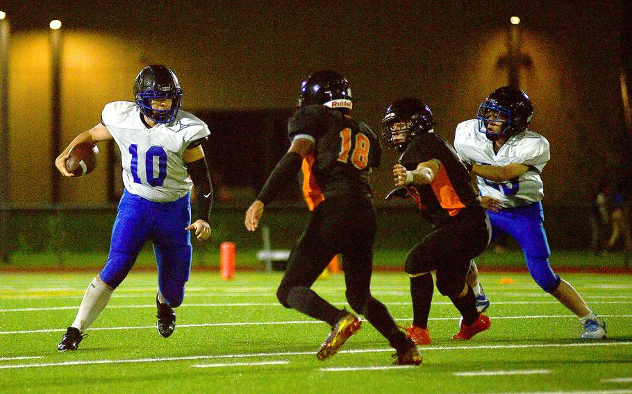 Brussels quarterback Sawyer Ter Horst looks to evade Sentinel defender Corderick Sago during a game on Sept. 29, 2023, at Spangdahlem High School in Spangdahlem, Germany.