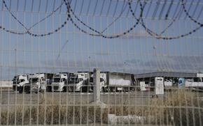 Trucks load with humanitarian aid for the Gaza Strip are seen at the Kerem Shalom Crossing in southern Israel, Tuesday May 20, 2025. (AP Photo/Maya Alleruzzo)