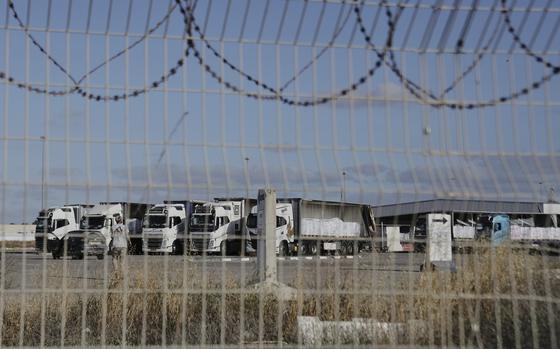 Trucks load with humanitarian aid for the Gaza Strip are seen at the Kerem Shalom Crossing in southern Israel, Tuesday May 20, 2025. (AP Photo/Maya Alleruzzo)