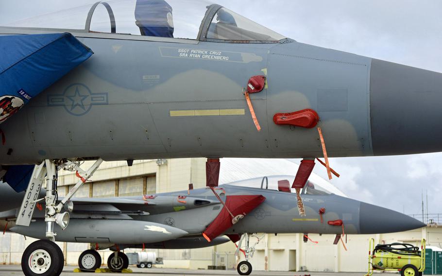 Two Air Force F-15C Strike Eagles assigned to the 67th Fighter Squadron sit near the flight lineat Kadena Air Base, Okinawa, Friday, April 21, 2023.