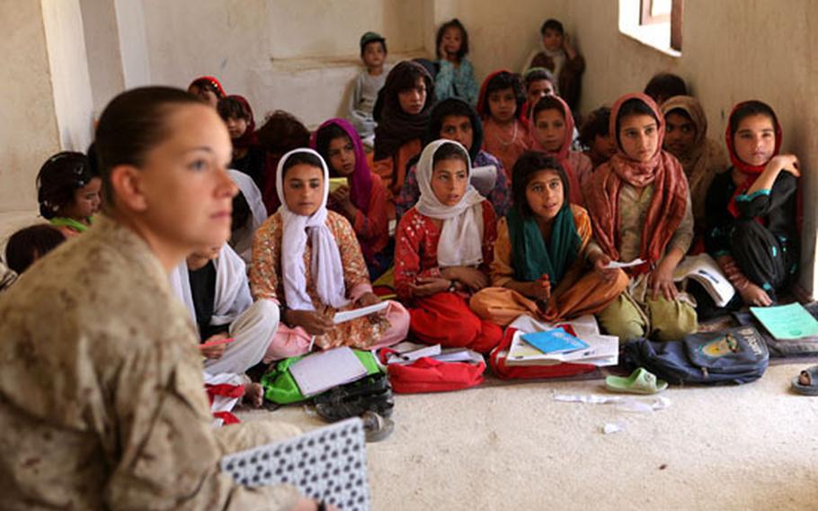 Afghan girls ranging from five to 12 years old in Nowzad, Afghanistan, attend a class on June 8, 2010.  They have only one male teacher and only regularly attend school 3 hours a day. In a report last week, the rights group Amnesty International said Afghan women and girls are enduring a “suffocating” crackdown by Taliban authorities, restricting their rights to free movement and education and leading to rising rates of forced marriage of girls.