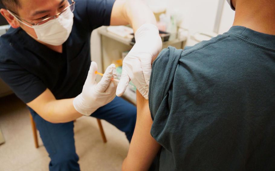 A teenger receives a COVID-19 vaccination at clinic in Tokyo, Wednesday, Sept. 29, 2021. 