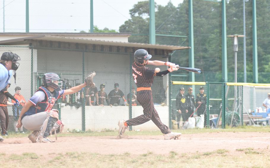 Spangdahlem's Landon Bueche just misses a pitch before it heads into the glove of Aviano catcher Cristiano Peterson on the opening day of the DODEA-Europe Division II/III baseball championships at Ramstein Air Base, Germany.