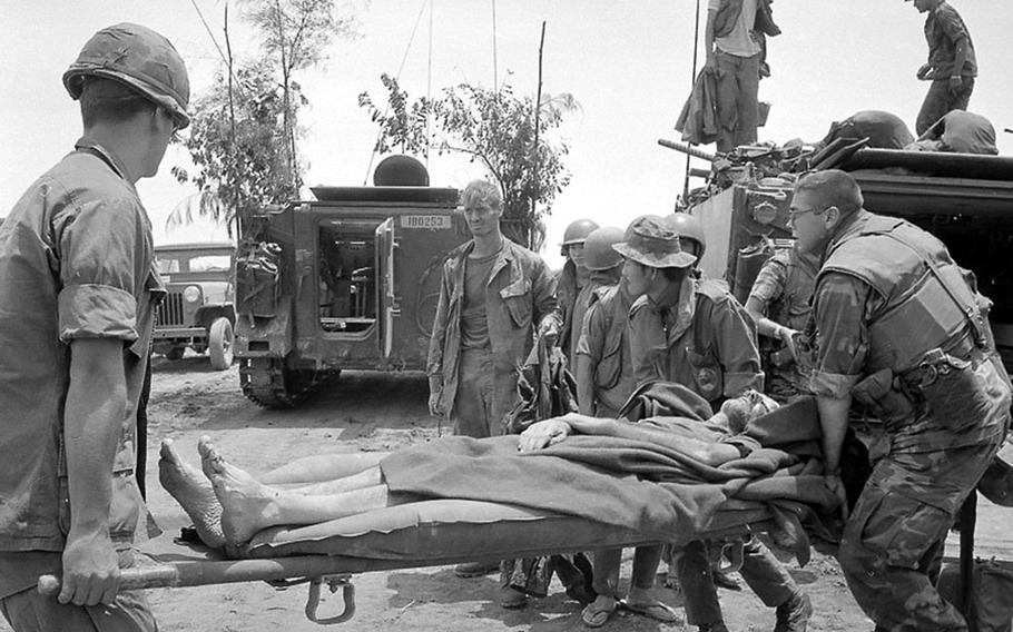 A wounded airman shot down over South Vietnam during the 1972 Easter Offensive is carried to an armored personnel carrier for evacuation.