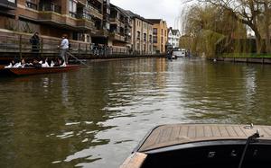 The River Cam stretches ahead of passengers in a punting boat in Cambridge, England, on Feb. 17, 2024. World-renowned colleges are located along the river.