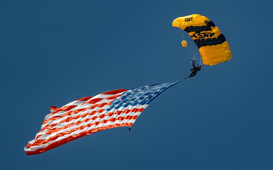 A soldier parachutes with the American flag