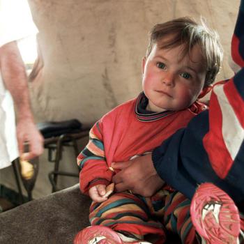 A young boy is about to be seen by a medical technican (left). He was  brought into the medical center of the Israeli Defense Force hospital at the Brazda Refugee Camp, April 14, 1999. The Israel medical facility has treated about 1,200 people so far. There have also been 9 babies born so far in this facility.