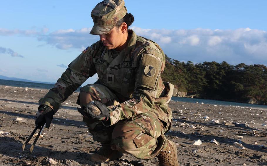 A U.S. soldier takes part in an effort to clean up Nobiru Beach in Miyagi prefecture, Japan, on Dec. 13.