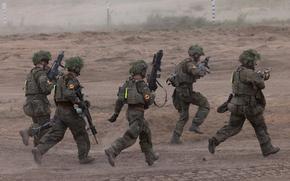 German soldiers take part in a drill during the NATO Quadriga military exercise, in Pabrade, Lithuania, on Wednesday, May 29, 2024. MUST CREDIT: Andrey Rudakov/Bloomberg