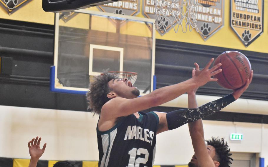 Naples' Keith Rascoe scored on this play - in the nearest basket - to help the Wildcats down Sigonella on Thursday, March 4, 2022, at the DODEA-Europe Division II basketball championships.