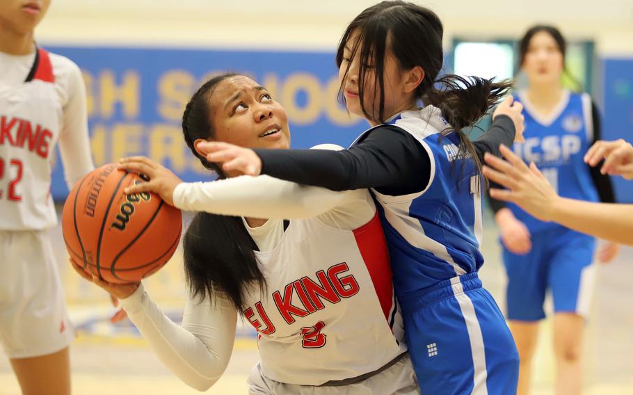 E.J. King's Moa Best looks to shoot against ICS-Pyeongtaek's Rachel Woo. The Cobras won 57-7.
