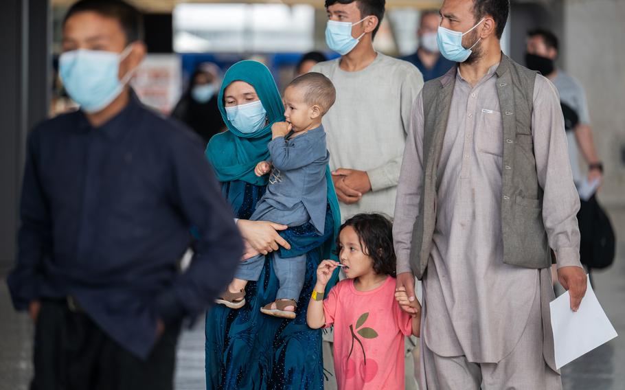 Afghan evacuees arrive at Dulles International Airport in August 2021. The health care needs of many of the evacuees, who are being housed temporarily at the Dulles Expo Center, have taxed Northern Virginia's hospital system, local officials say. 