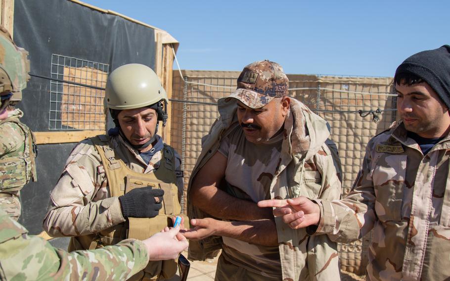 U.S. Soldiers with 1st Battalion, 5th Infantry Regiment, 1st Stryker Brigade Combat Team, 25th Infantry Division, share medical supplies with Iraq Army soldiers charged with guarding Al Asad Airbase in western Iraq, Feb. 14, 2020. The 25th ID regularly conducts presence patrols around the perimeter of Al Asad Airbase to support Iraqi troops and strengthen the security partnership between the two nations. (U.S. Army photo by Sgt. Sean Harding)