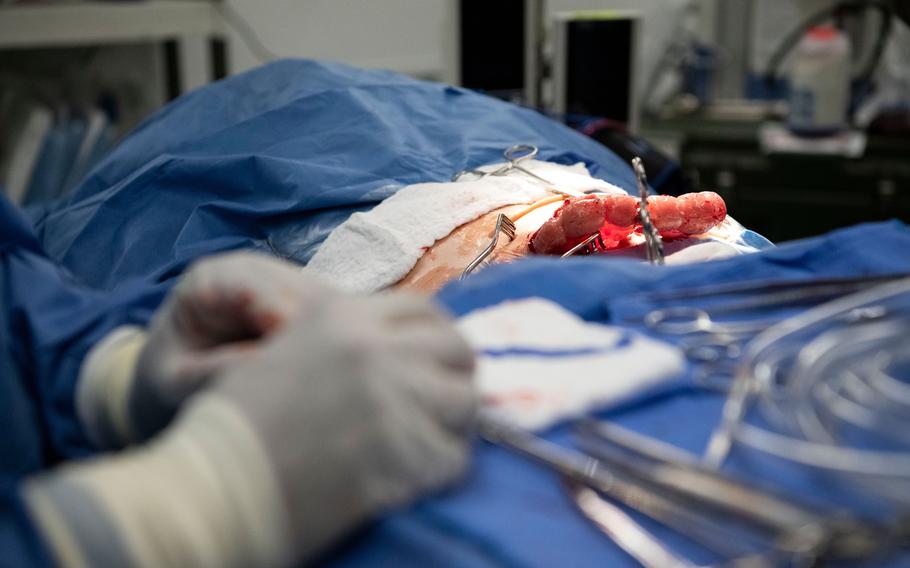 U.S. Army medics expose plastic organs during a surgical operation on a mannequin at a temporary field hospital at Baumholder Army Airfield, Germany, on May 17, 2024. 