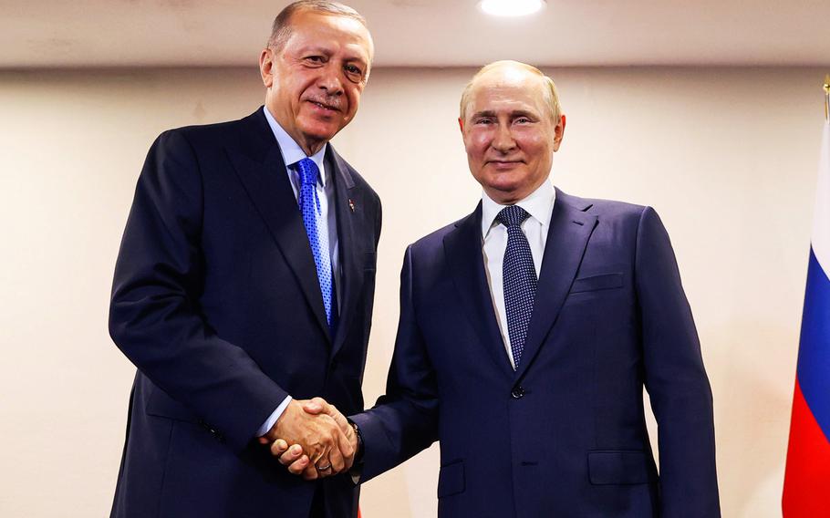 Turkish President Recep Tayyip Erdogan, left, shakes hands with Russian President Vladimir Putin during their meeting, in Tehran, Iran.