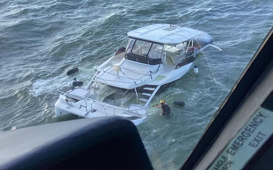 Two boaters and a dog were pulled from a catamaran as it sank off the coast of Georgia, Monday, May 1, 2023, Coast Guard officials said.