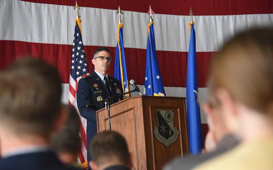 A man speaking at a podium emblazoned with the insignia of the 185th Air Refueling Wing.