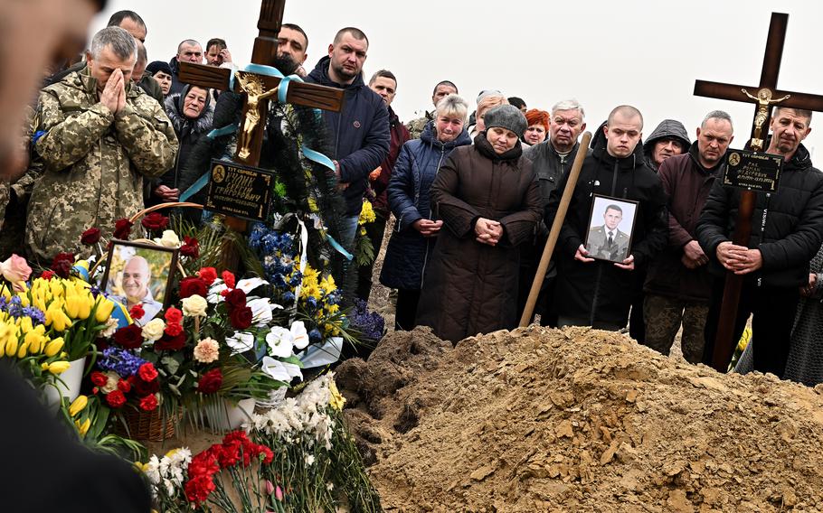 Mourners gather for the burial of two Ukrainian soldiers during a funeral Wednesday, March 16, 2022.