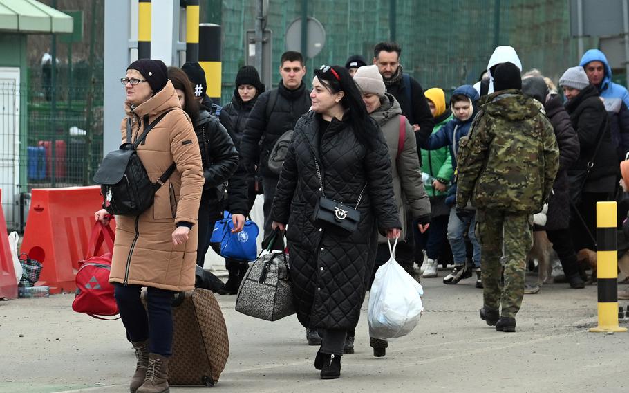Refugees walk across the Ukrainian-Polish border at Medyka, Poland, in early March 2022. The commander of the U.S. Army garrison in Italy took to social media to warn DOD-affiliated Americans there to think twice about hosting Ukrainian refugees, citing legal issues and risks.