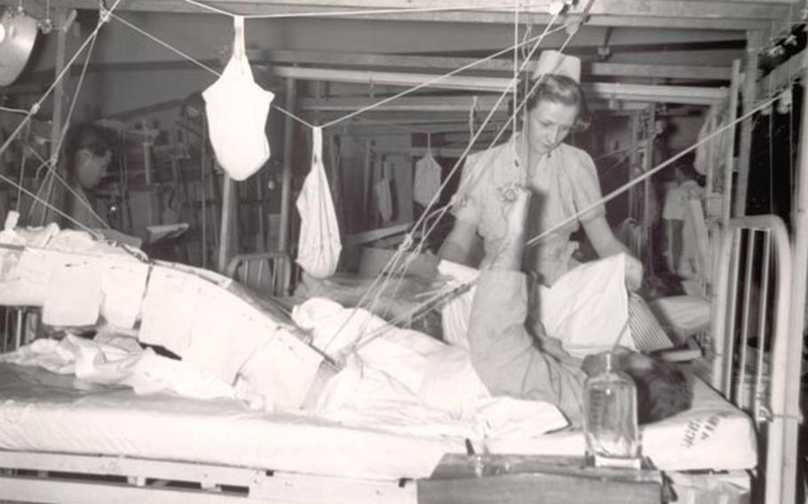 Lt. Helen Maystrovich treats a soldier wounded in Korea at the Tokyo Army Hospital Jan 12, 1951.