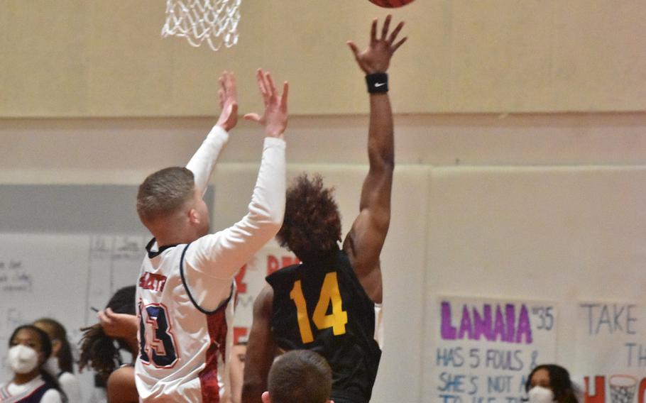 Vicenza’s Tyler Suber puts up a shot before Aviano’s Aidan Haas can get a hand on it Friday, Feb. 4, 2022, in the Saints’ 51-48 victory.