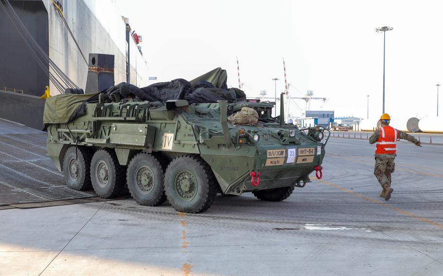 Soldiers guide a Stryker vehicle to a staging area after being unloaded from a transport ship in South Korea, Jan. 30, 2024. 