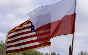 The U.S. and Polish flags fly at the airfield in Powidz, Poland, March 3, 2025. Defense Secretary Pete Hegseth met with his Polish counterpart Tuesday at the Pentagon and called for stronger U.S.-Polish ties.