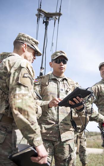 US Army soldiers talking to each other.
