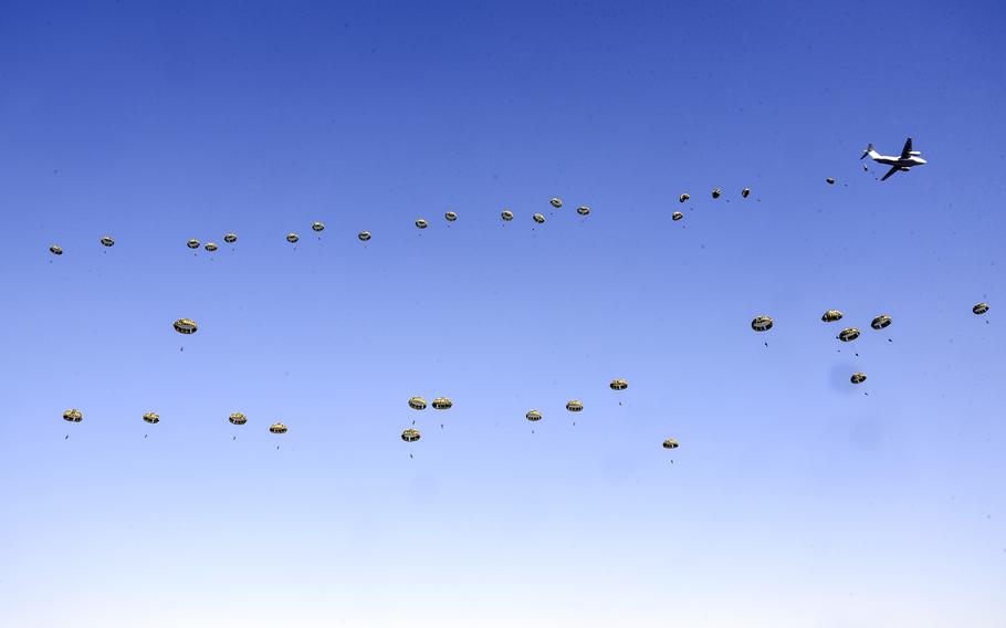 Paratroopers jump from a Japan Air Self-Defense Force Kawasaki C-2 Greyhound over Camp Narashino in Chiba prefecture, Japan, Jan. 8, 2023. 