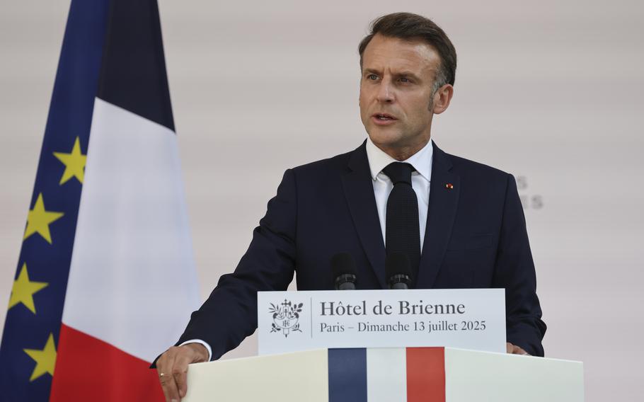 Macron speaks, with French and NATO flags behind him.