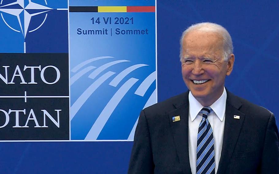 U.S. President Joe Biden smiles as he poses at the official greeting by NATO Secretary-General Jens Stoltenberg to the NATO summit in Brussels, Belgium, June 14, 2021.