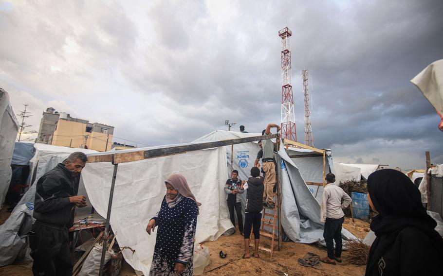 Displaced Palestinians build temporary shelters at a camp operated by UNWRA, in Khan Younis, Gaza. 