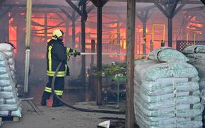 A Ukrainian firefighter intervenes to extinguish a fire at a hardware superstore following a Russian strike, in Kharkiv, on May 25, 2024.