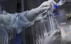 An employee prepares a syringe of raw materials for messenger RNA, the first step of Covid-19 vaccine production, at the BioNTech laboratory in Marburg, Germany, on March 27, 2021. MUST CREDIT: Bloomberg photo by Cyril Marcilhacy.