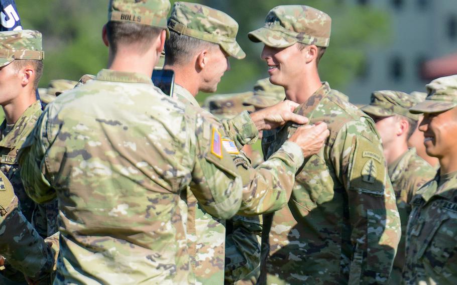 
Army Maj. Gen. David Hodne, the Army’s infantry commandant, pins jump wings on a soldier graduating the Army’s Basic Airborne Course at Fort Benning, Ga. on Friday, May 21, 2021. The ceremony was the first public graduation for the Army’s Airborne School since the coronavirus pandemic began more than one year ago. 