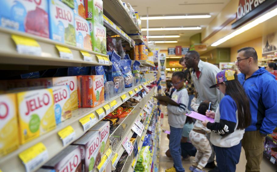 Students from Arnn Elementary School take part in Math Night with their parents at the commissary in the Sagamihara Housing Area near Camp Zama, Japan, Nov. 16, 2023. 