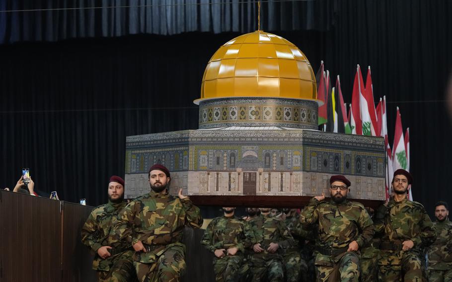 Hezbollah fighters hold a replica of the Dome of the Rock Mosque as march during a rally to mark Jerusalem day or Al-Quds day, in a southern suburb of Beirut, Lebanon, Friday, April 29, 2022. 