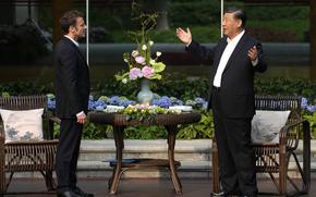 Chinese President Xi Jinping, right, and France's President Emmanuel Macron talk prior to a tea ceremony at the Guandong province governor's residence in Guangzhou, China, on April 7, 2023. French President Emmanuel Macron will seek to press China's Xi Jinping to use his influence to move Russia toward ending the war in Ukraine during a two-day state visit to France. Both leaders were also expected to discuss trade disputes over electric cars, cognac and cosmetics.
