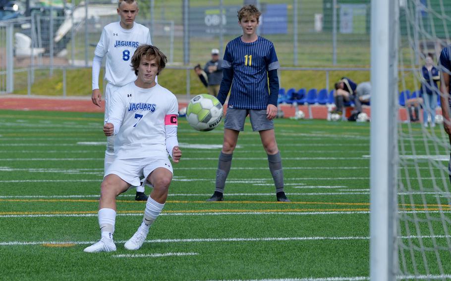 Sigonella’s Tim Garcia watches his penalty kick sail towards the goal for the Cougars 3-1in the Division III boys final against Ansbach, at the DODEA-Europes soccer championships in Ramstein, Germany, May 18, 2023. Sigonella won 4-1. Watching are Christopher Mathias Hedemand, left, and Benjamin Schuck.