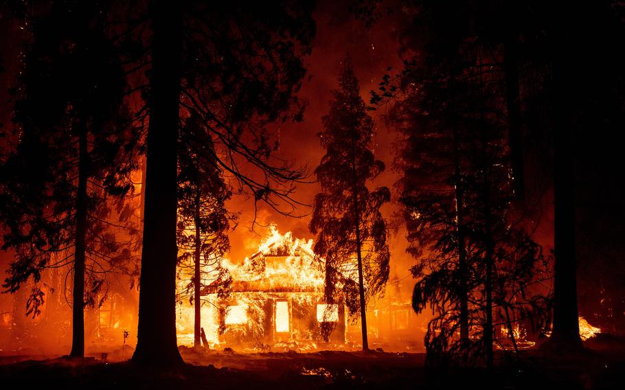 A home burns as flames from the Dixie fire tear through the Indian Falls neighborhood of unincorporated Plumas County, Calif., on July 24, 2021. 