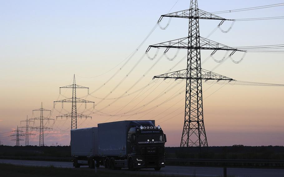 A truck travels along a highway past electricity towers and power lines near Lttow-Valluhn, Mecklenburg-Vorpommern, Germany, on Aug. 24, 2022. 
