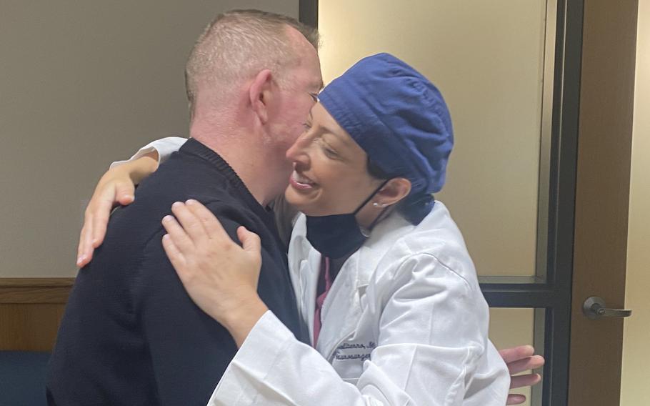 Dr. Jennifer Moliterno, right, and her patient, Army veteran Joe Brennan, embrace at a recent meeting.