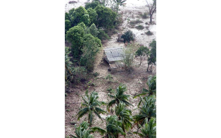 A house is covered almost entirely by mud after a series of massive storms slammed the Philippines.