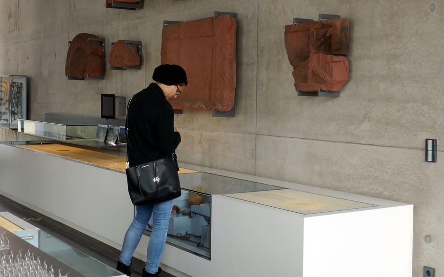A visitor looks at the Roman artifacts displayed at the Roemermuseum in Osterburken, Germany. The Limes, a defensive boundary between Rome and the Germanic tribes, once ran near here.