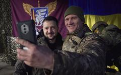 In this photo provided by the Ukrainian Presidential Press Office, Ukrainian soldier takes a selfie with President Volodymyr Zelenskyy, left, during his visit to Sloviansk, Donbas region, Ukraine, Tuesday, Dec. 6, 2022. (Ukrainian Presidential Press Office via AP)