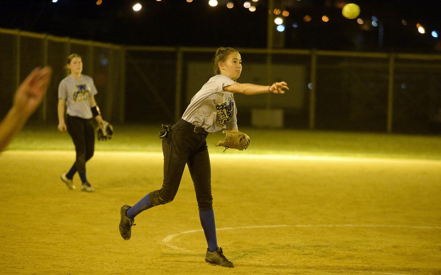 Yokota pitcher Erica Haas throws to first base against Kubasaki during Friday's softball doubleheader. The Dragons swept the Panthers 19-18 and 14-7.