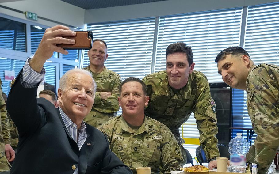 President Joe Biden takes a selfie while eating pizza with U.S. and NATO troops near Rzeszow, Poland, on March 25, 2022. The restaurant, which is popular with troops, later named the type Biden ate the "Spicy Joe."