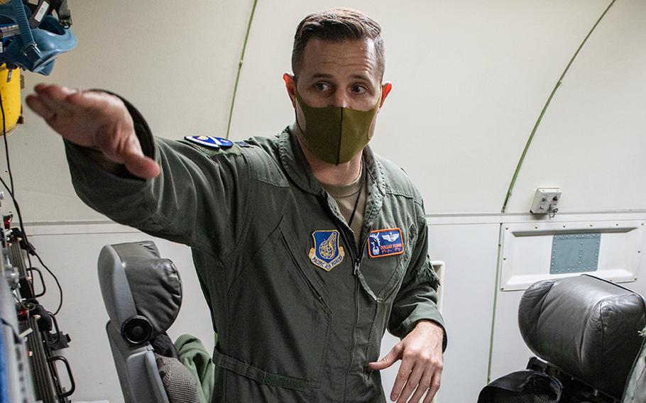 Lt. Col. Alexander Demma, then-commander of the 961st Airborne Air Control Squadron at Kadena Air Base, Okinawa, points out upgrades aboard an E-3G Sentry, Jan. 13, 2022. 